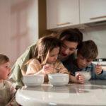 happy mom with young children in kitchen