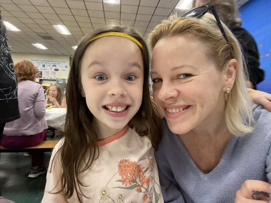 Mother and daughter at school celebration.